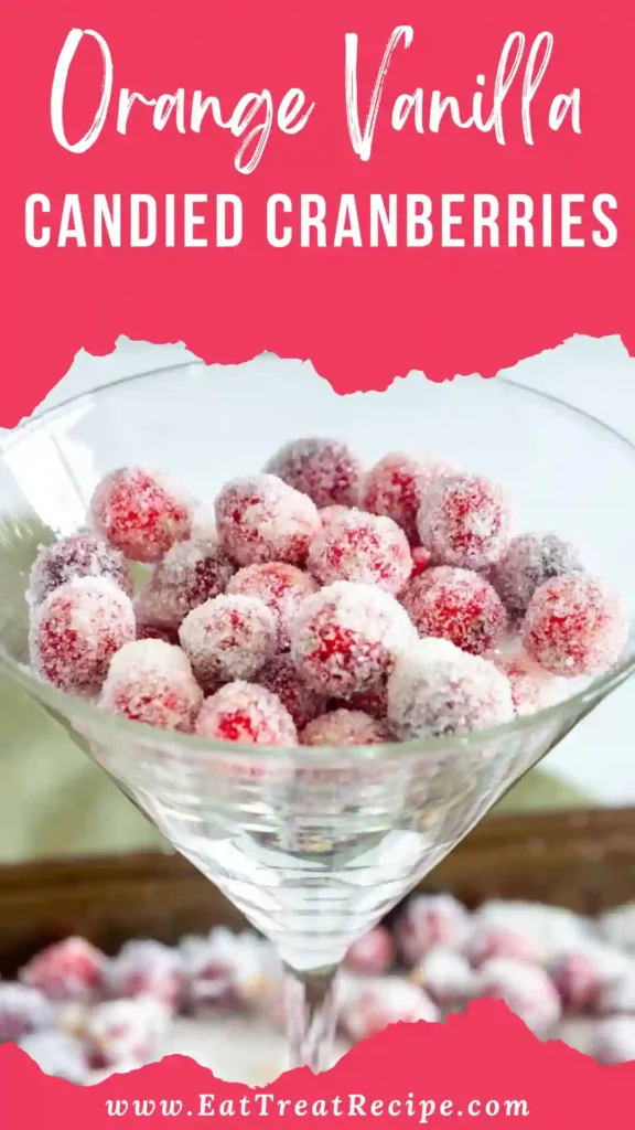 Orange vanilla candied cranberries sparkling in a glass bowl on white marble background