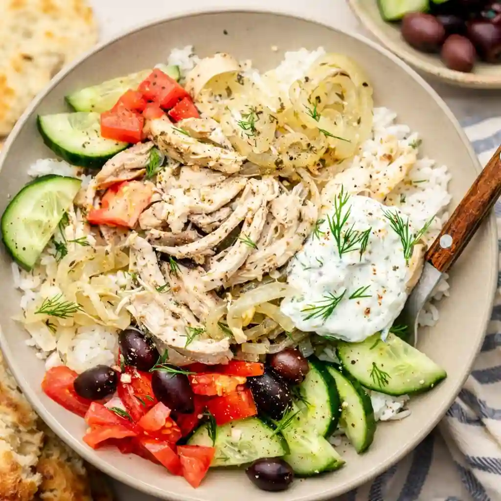 Slow Cooker Greek Chicken with lemon and herbs in a minimalist bowl