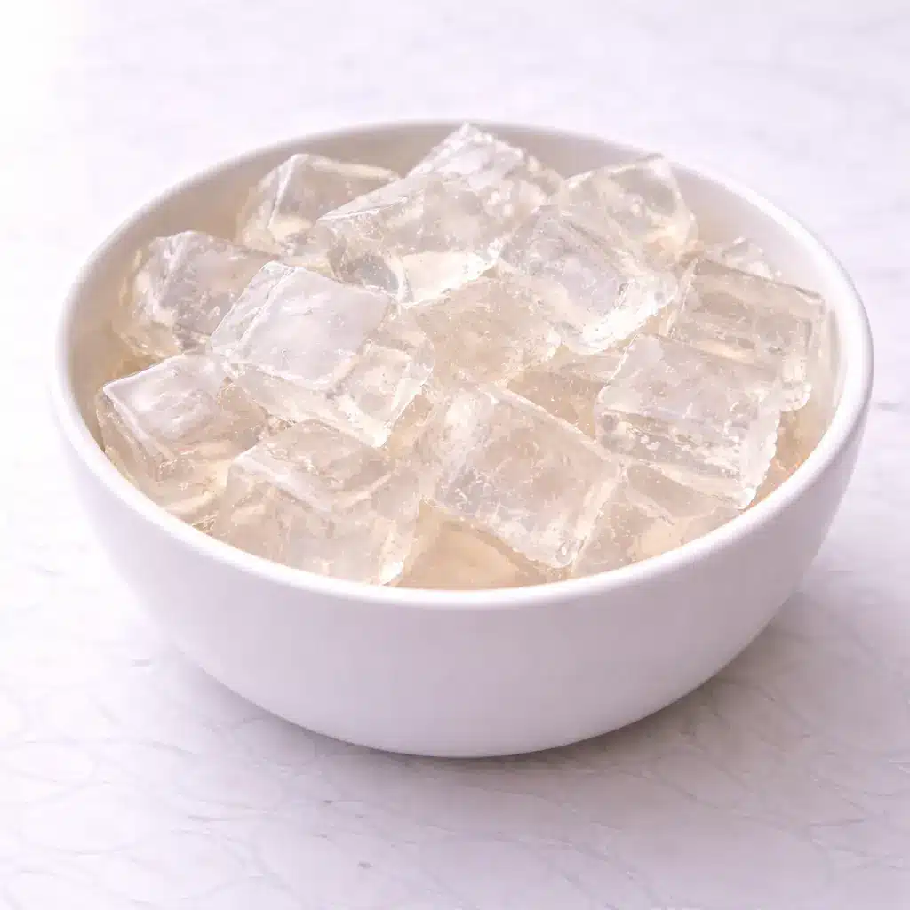 Gelatin Trick Recipe drink in clear glass mug on white marble surface