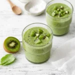 An opened glass meal prep tumbler displaying a fresh quick kiwi breakfast smoothie.